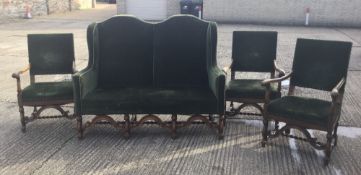 An early 20th century camel back settee and three matching armchairs