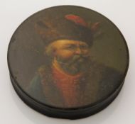 A 19th century papier mache snuff box depicting a Russian gentleman