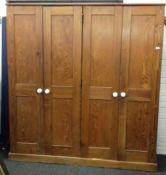 A Victorian pitch pine four door school cupboard