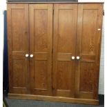 A Victorian pitch pine four door school cupboard