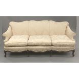 A late 19th/early 20th century mahogany framed three seat upholstered settee,