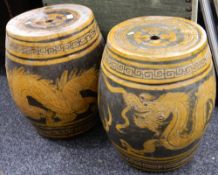 A pair of Oriental pottery garden seats decorated with dragons