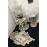 A Capodimonte oil lamp decorated with cherubs,