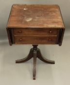 A 19th century mahogany twin flap pedestal Pembroke table