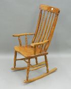 A Victorian elm seated splat back rocking chair