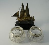 A Chinese silver model of a junk and two silver mounted glass salts