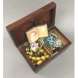 A tea caddy containing a quantity of miscellaneous costume jewellery, etc.