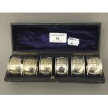 A cased set of silver plated napkin rings
