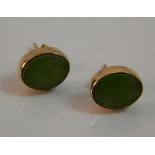 A pair of 14 K gold and jade earrings
