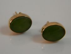 A pair of 14 K gold and jade earrings