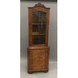 A modern walnut glazed corner cabinet