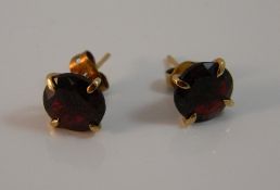 A pair of 9 ct gold and garnet earrings