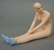 A porcelain figure of a nude lady