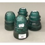 Four vintage green glass electricity isolators