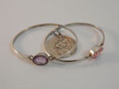 Two silver bangles and a St Christopher pendant