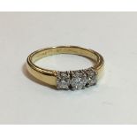 An 18 ct gold diamond three stone ring (3.