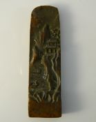 A bronze seal decorated with a mountainous landscape