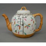 A 19th century Staffordshire teapot with faux bamboo decoration