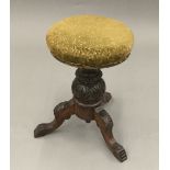 A Victorian revolving piano stool