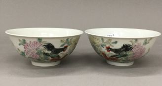 A pair of Chinese porcelain bowls each decorated with chicken