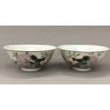 A pair of Chinese porcelain bowls each decorated with chicken