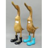 A pair of wooden ducks in boots