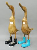 A pair of wooden ducks in boots