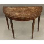 A mahogany demi lune card table