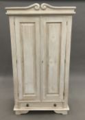 A white painted pine wardrobe. 179 cm high, 58 cm deep, 98 cm wide.