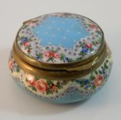 A circular enamel pill box