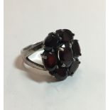 A silver and almandine garnet ring