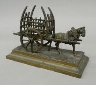 A bronze model of a horse and cart