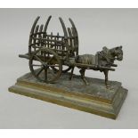 A bronze model of a horse and cart