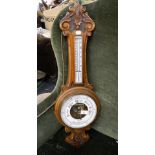 An oak cased aneroid barometer