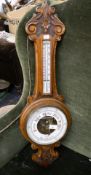 An oak cased aneroid barometer