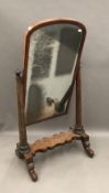 A Victorian mahogany cheval mirror