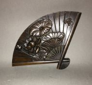 A bronze box formed as a fan