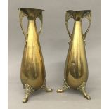 A pair of Arts and Crafts brass vases