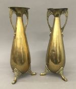 A pair of Arts and Crafts brass vases