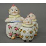 A porcelain clown cruet set