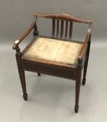 An Edwardian mahogany piano stool