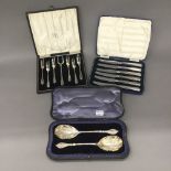 A pair of cased silver gilt serving spoons,