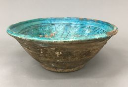 A Persian pottery turquoise glazed bowl