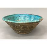 A Persian pottery turquoise glazed bowl