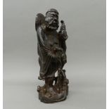 A Chinese carved wooden figure of an immortal