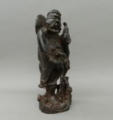 A Chinese carved wooden figure of an immortal