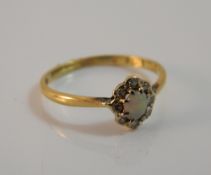 An 18 ct gold opal and diamond cluster ring (1.