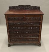 A Chinese carved hardwood chest of drawers