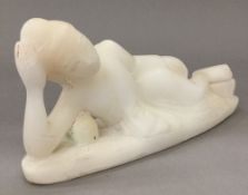 A carved alabaster figure of Buddha modelled reclining