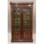 An inlaid mahogany glazed cabinet